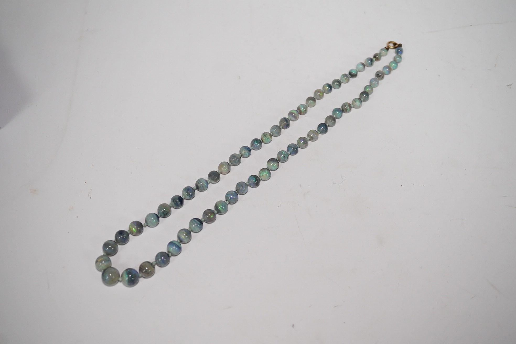 A single strand graduated blue opal bead necklace, with 9ct clasp, retailed by Liberty & Co?, 44cm, with Liberty & Co box. Condition - fair to good